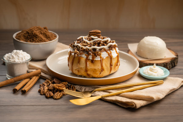 Everything you love about our original
Cinnamon Roll with an artisan twist.
The Pecan Roll is topped with our
creamy caramel fudge, roasted
pecans, and exquisite cream cheese
frosting. Simply the perfect treat!